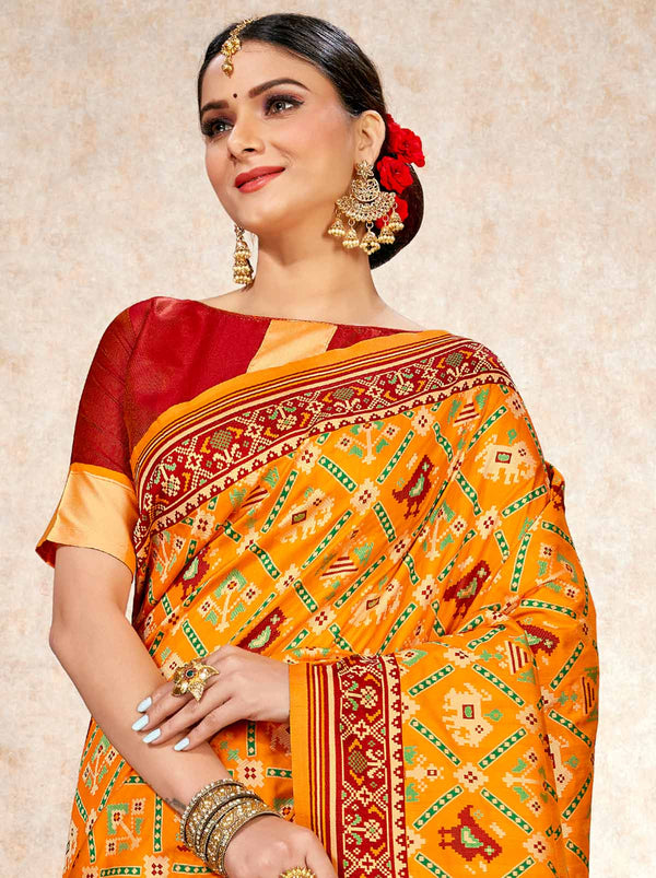 Sunrise Yellow patola saree with a red silk-blend blouse - TrendOye