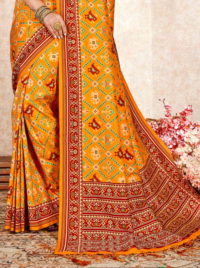 Sunrise Yellow patola saree with a red silk-blend blouse - TrendOye